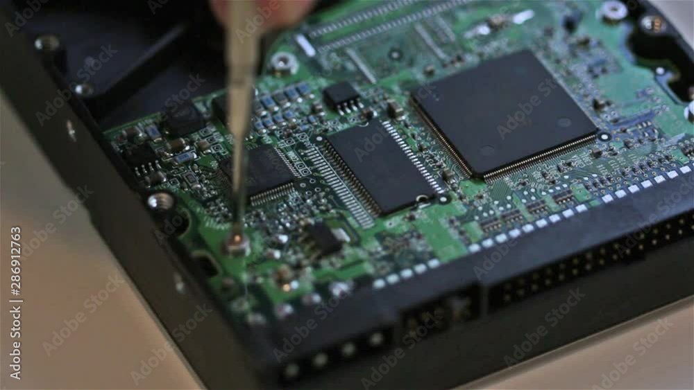 Serviceman is repairing hard disk Serviceman is repairing hard disk