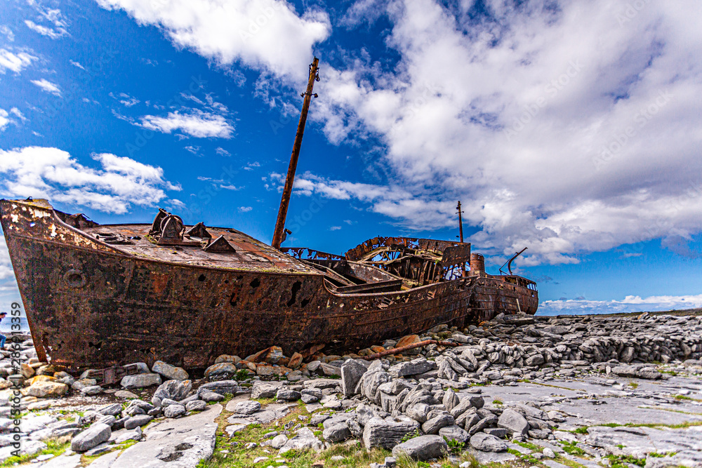 Stunning view of the Plassey shipwreck on the rocky beach of Inis Oirr island, abandoned ship, old, rusty with time, wonderful sunny day with an intense blue sky in Aran Islands, Ireland