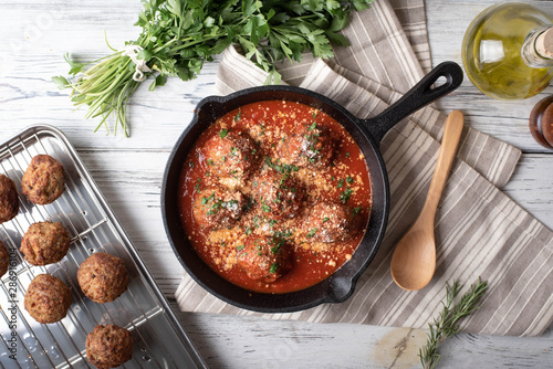 meatballs with tomato sauce in cast iron skillet photo