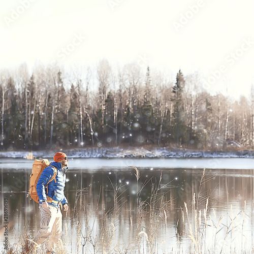 winter landscape man with a backpack / nature landscape a man on a hike with equipment in snowy weather in Canada