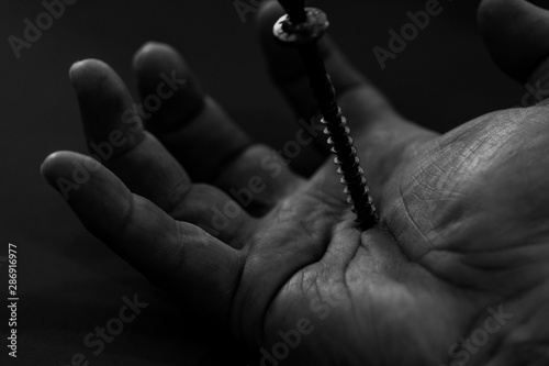 hand of a man with a screw in it