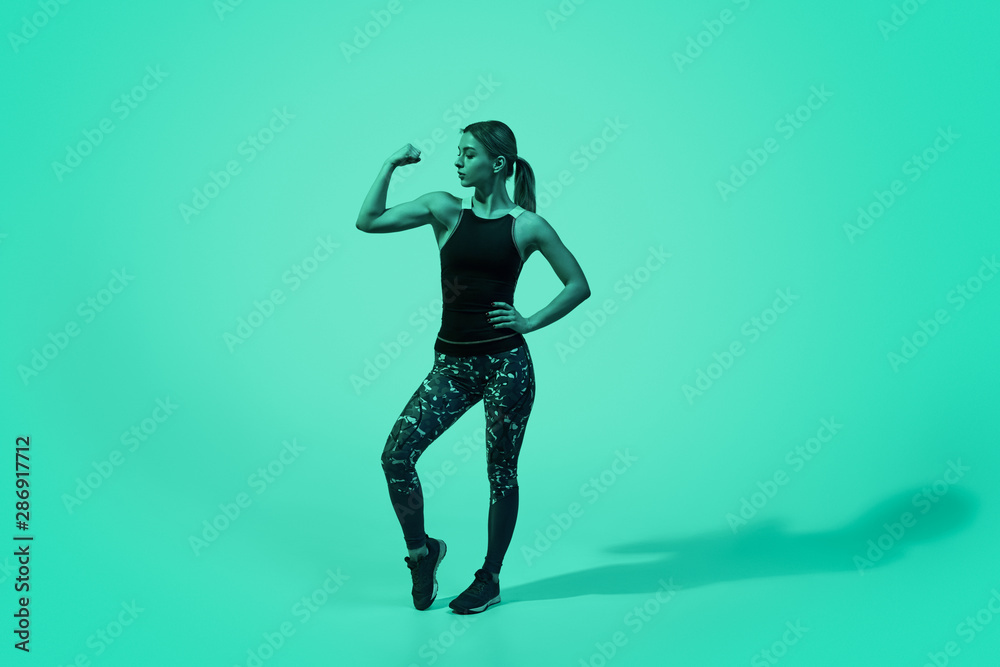 Strong woman flexing arm muscles