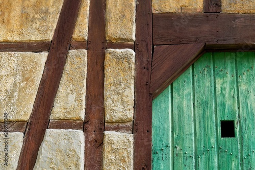 Wooden construction on the wall of an old half-timbered house. The building is being renovated.