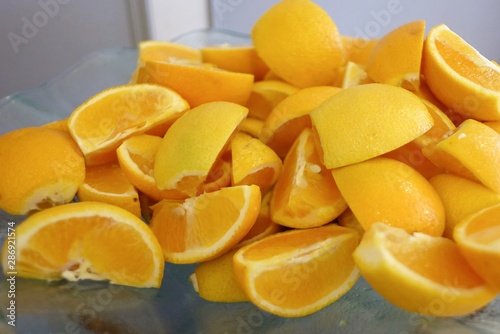 A pile of fresh orange slice in a bowl on a dinning table