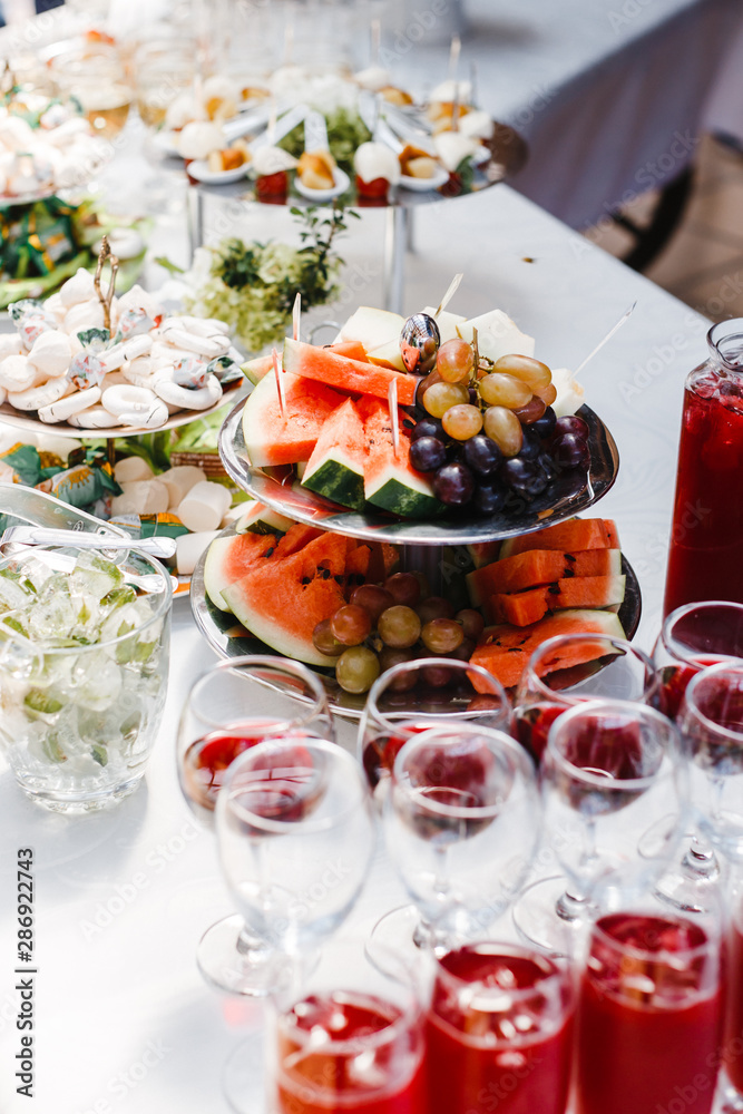 buffet table with wine and juice, fruits and sweets, snacks and mint ice