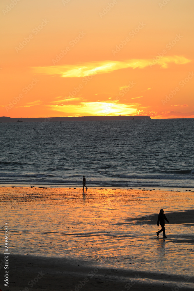 Sunset and Kitesurfers on the beach in Saint Malo,  Brittany, France