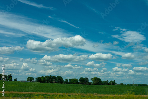 landscape - green field & cloudy skies