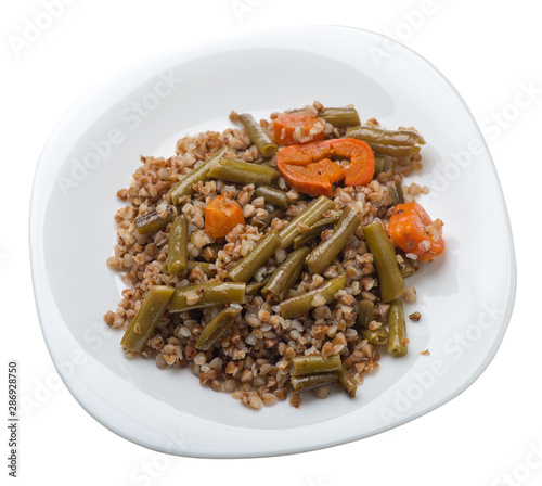 buckwheat with green beans with garlicand carrots isolated on white background. Diet breakfast on a green plate. healthy food vegetarian photo