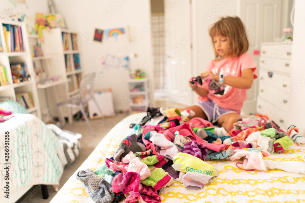 Girl Sorting Socks in Bedroom Girl Sorting Socks in Bedroom