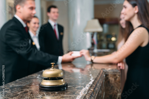 Picture of guests getting key card in hotel.