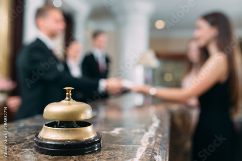 Picture of guests getting key card in hotel.