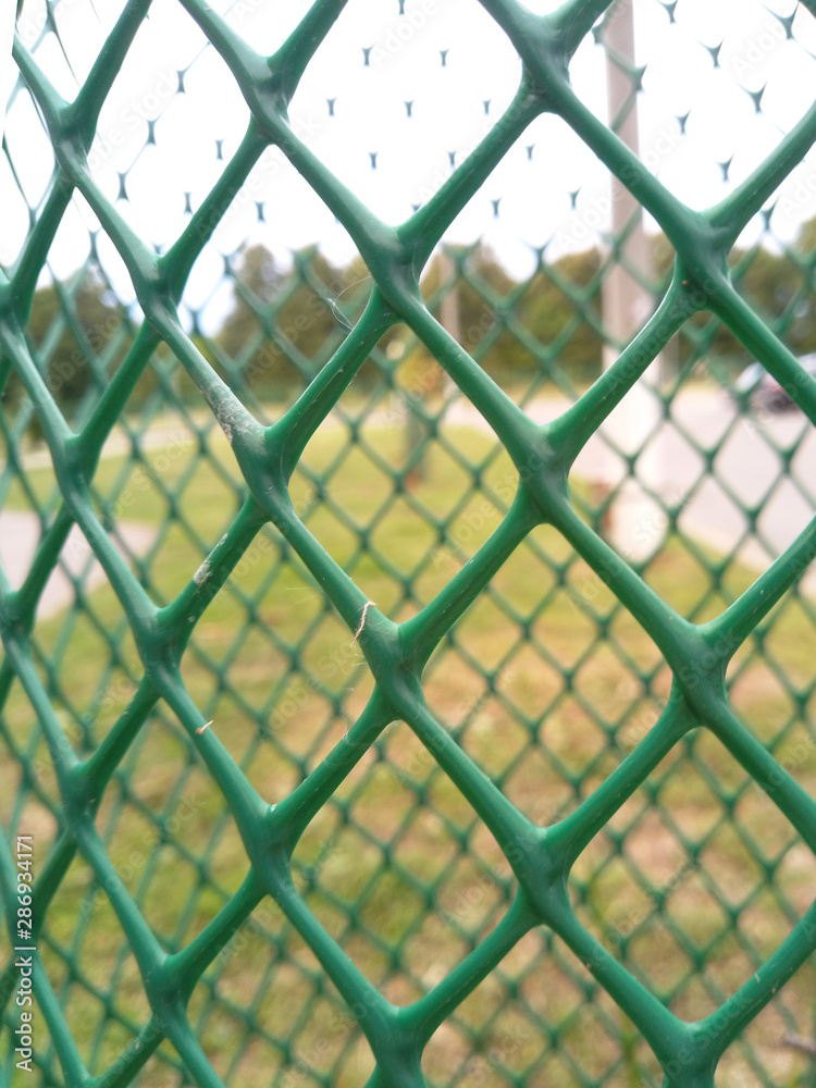 Fototapeta premium street plastic green fence net