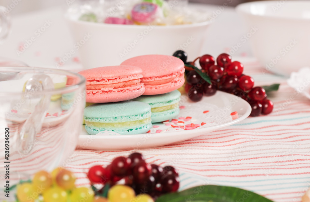 Naklejka premium French colorful macaroons. Colorful pastel macaroons on white background. Pink and blue macaroons. Still life in pink and white