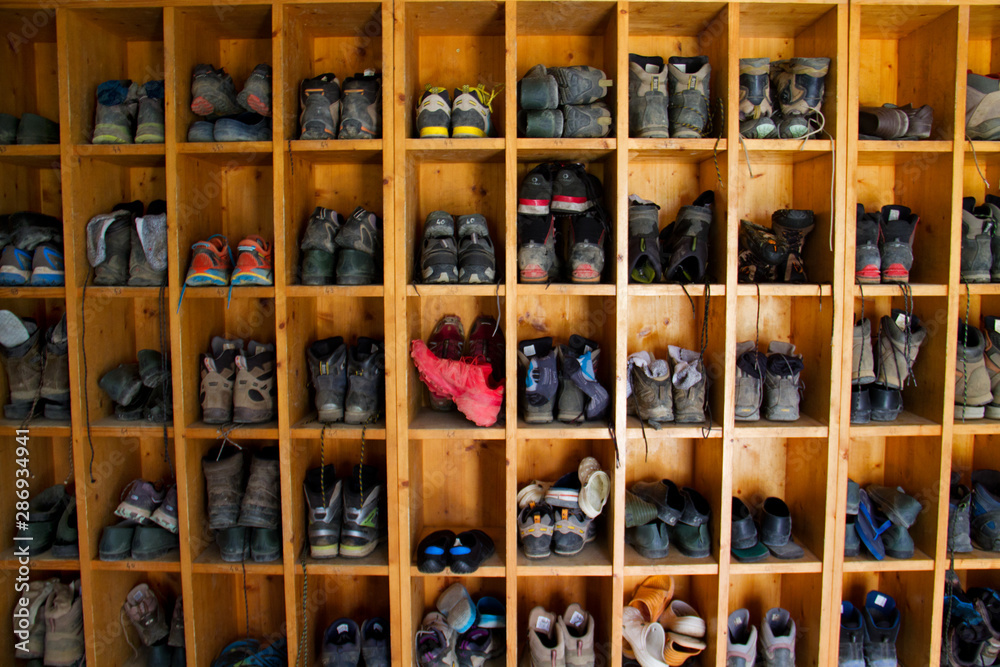 Collection of hiking boots in a mountain cabin in the Pyrenees
