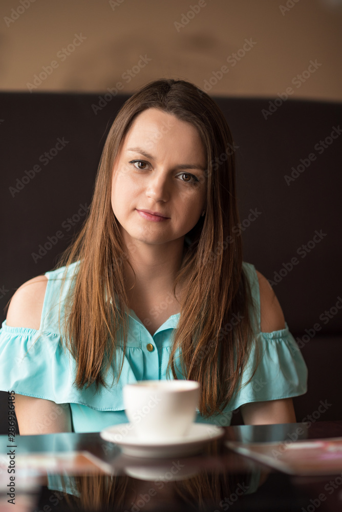 Portrait of a beautiful girl resting in a cafe. Portrait of a beautiful girl resting in a cafe.