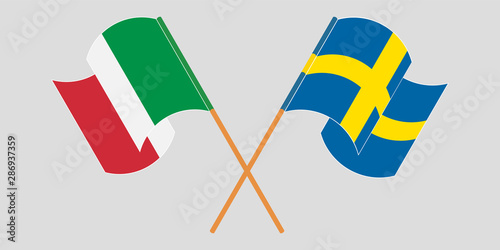 Crossed and waving flags of Italy and Sweden