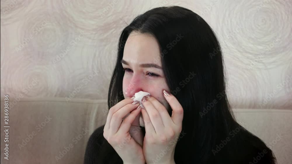 Sick woman sneezes and coughs. Viral diseases in the cold period. Sick woman sneezes and coughs. Viral diseases in the cold period.