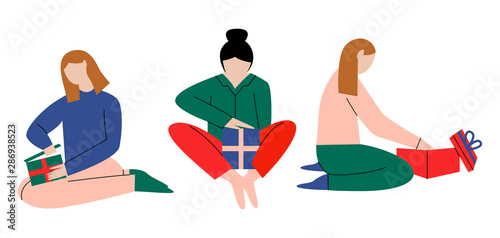 Set of women opening Christmas presents. Women sitting on the floor holding decorated boxes with surprise presents. Flat vector illustration