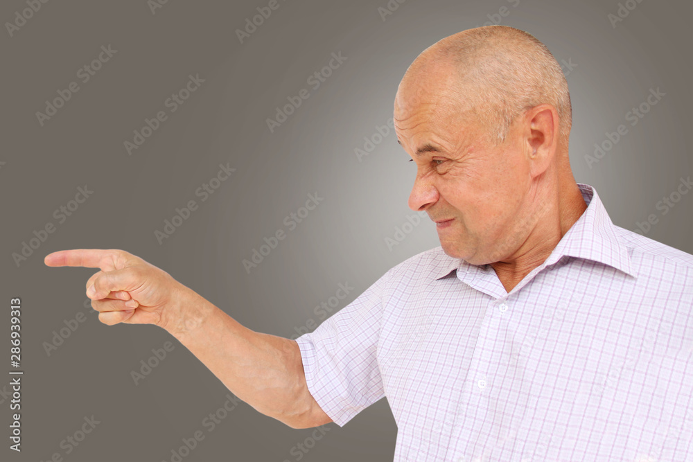 angry man in a light shirt accusing him of cruelty holds his hand, horizontal, close-up, copy space angry man in a light shirt accusing him of cruelty holds his hand, horizontal, close-up, copy space