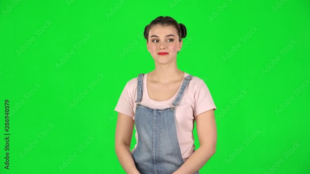 Girl coquettishly smiles and showing heart with fingers then blowing kiss Girl coquettishly smiles and showing heart with fingers then blowing kiss