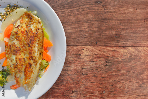 Tasty tilapia with vegetables as a side.
