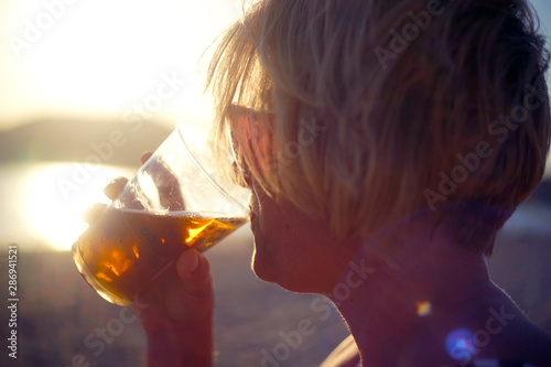 silhueta de mulher bebendo na praia  photo