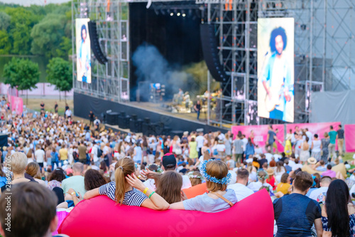 Women are watching concert at open air music festival