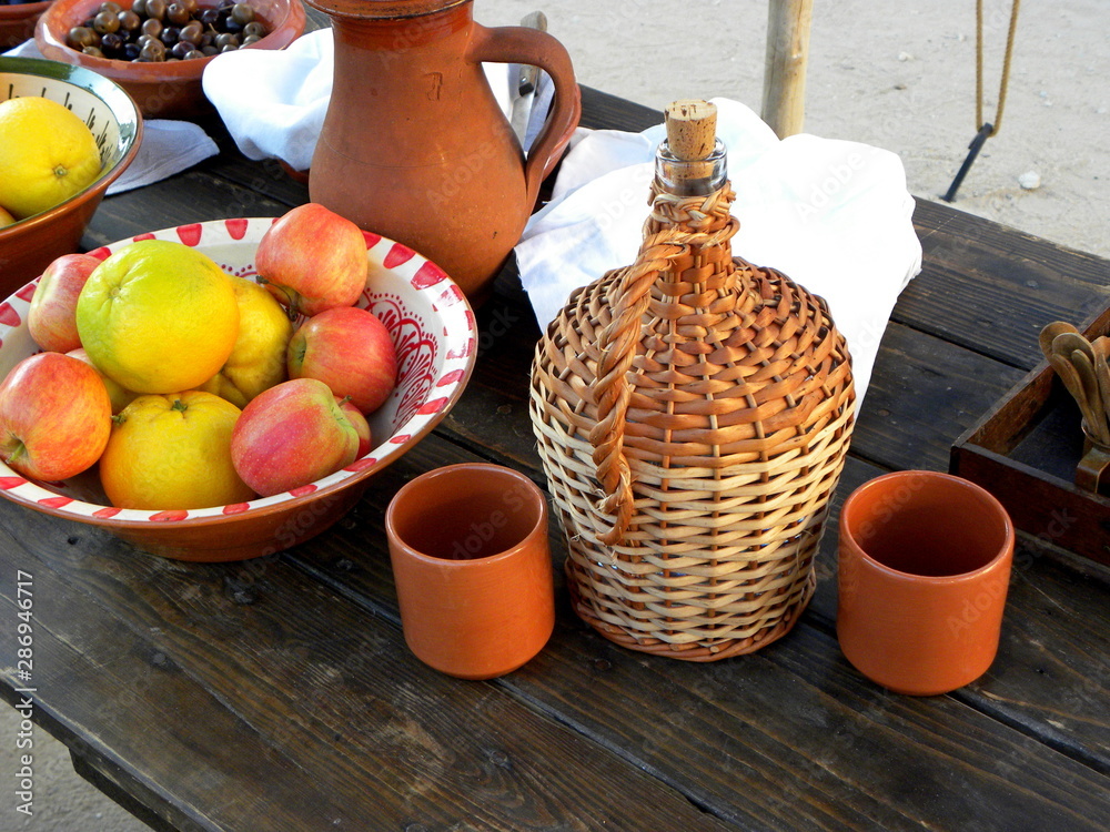 still life with jug, clay mugs and fruits