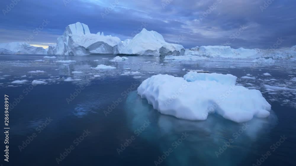 Beauty of Disko Bay with icebergs floating in water Beauty of Disko Bay with icebergs floating in water