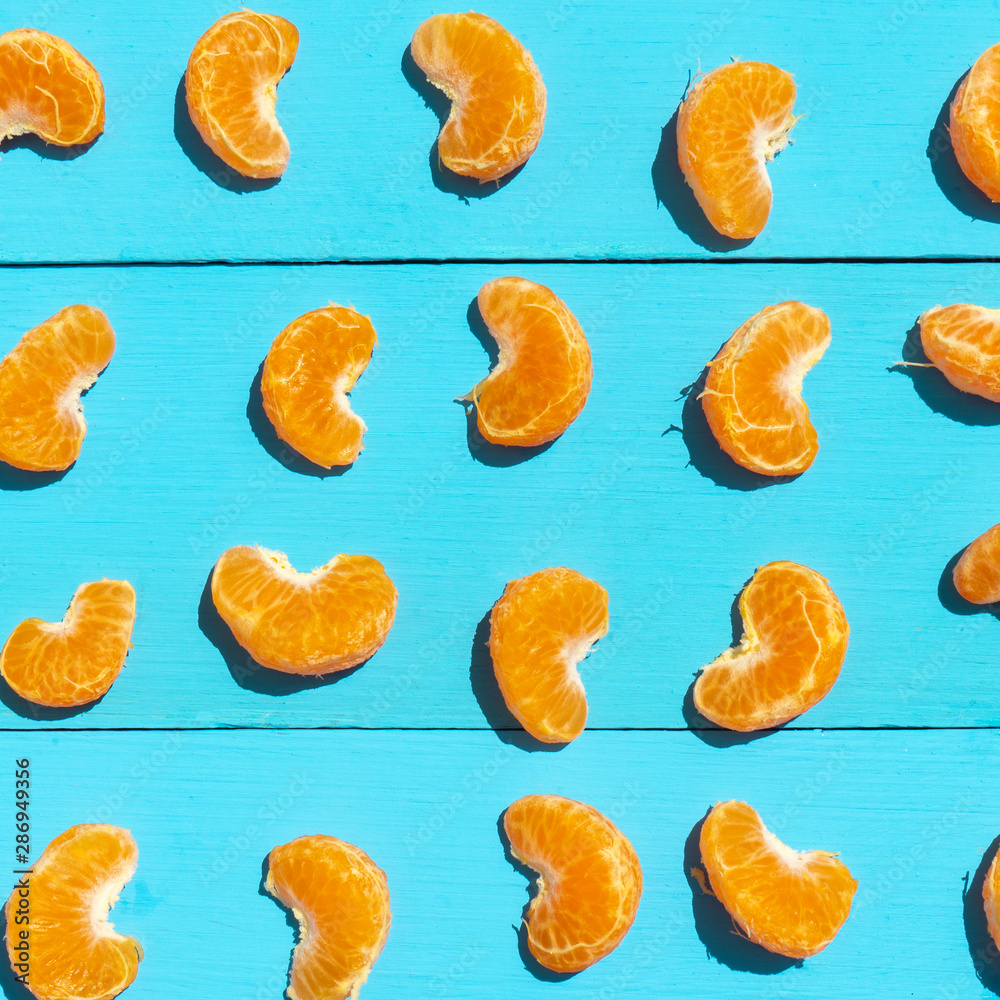 Segments of tangerine on blue background Segments of tangerine on blue background