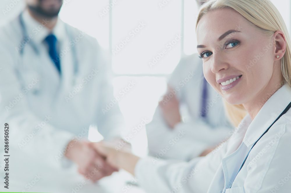 Doctor shaking hands with a male patient in the office