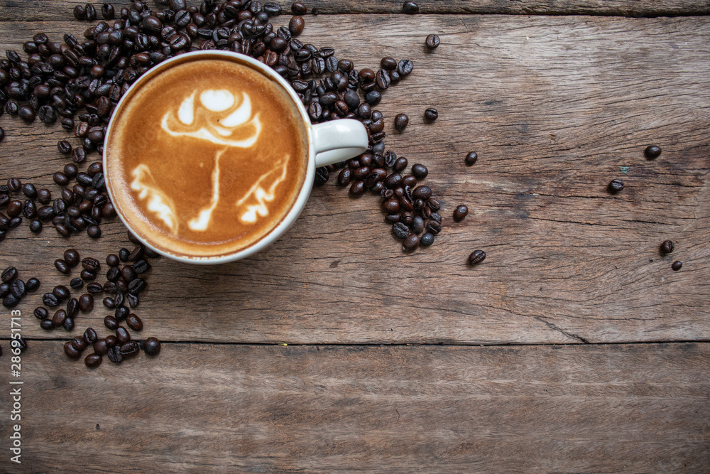 Coffee in a white mug and coffee beans on a wooden table Coffee in a white mug and coffee beans on a wooden table