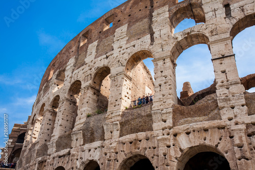 ROME, ITALY - APRIL, 2018: Tourists visiting the famous Colosseum or Coliseum also known as the Flavian Amphitheatre in the centre of the city of Rome