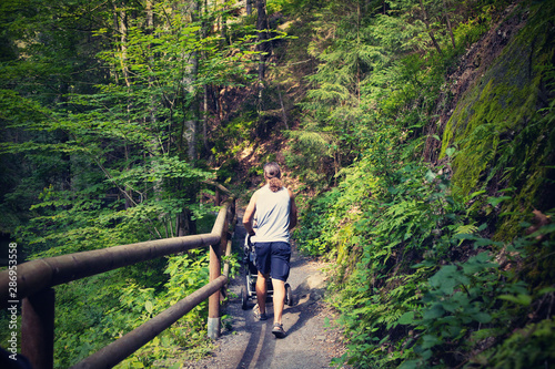 A man with a pram on the tourist route.Czech Switzerland National Park. A national park famous for its sandstone formations, wild valleys and frozen waterfalls.