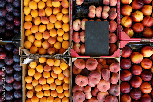 fresh fruit in crates at the market. blank price tag