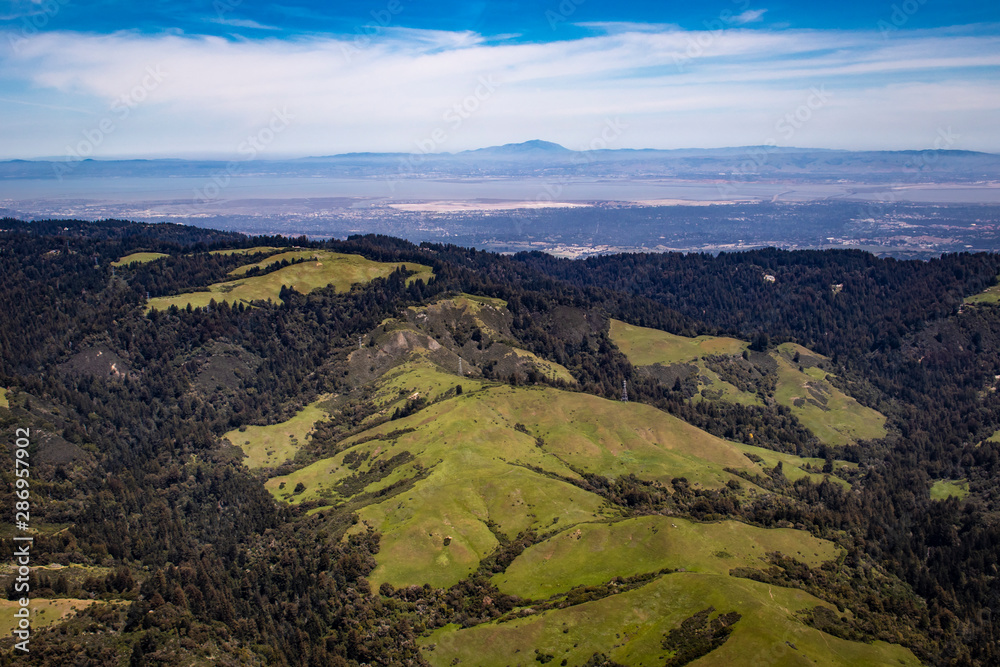 Aerial View Looking Back over the Forests and Mountains towards Silicon Valley on the Horizon in the San Francisco Bay Area, California, USA