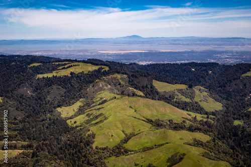 Aerial View Looking Back over the Forests and Mountains towards Silicon Valley on the Horizon in the San Francisco Bay Area  California  USA