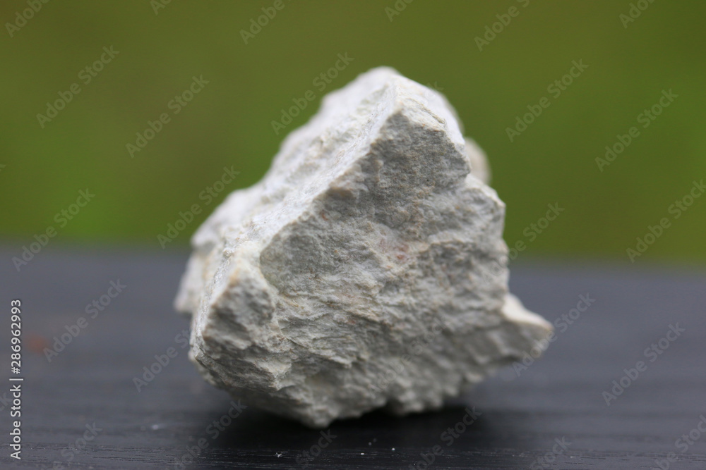 Kaolinite stone isolate on green background Kaolinite stone isolate on green background