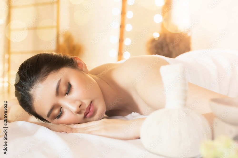 Asian Beautiful, young and healthy woman in spa salon. Massage treatment spa room  . Traditional medicine and healing concept.