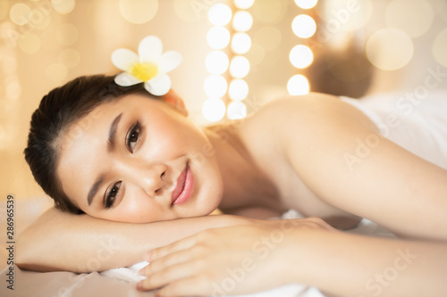 Asian Beautiful, young and healthy woman in spa salon. Massage treatment spa room  . Traditional medicine and healing concept.