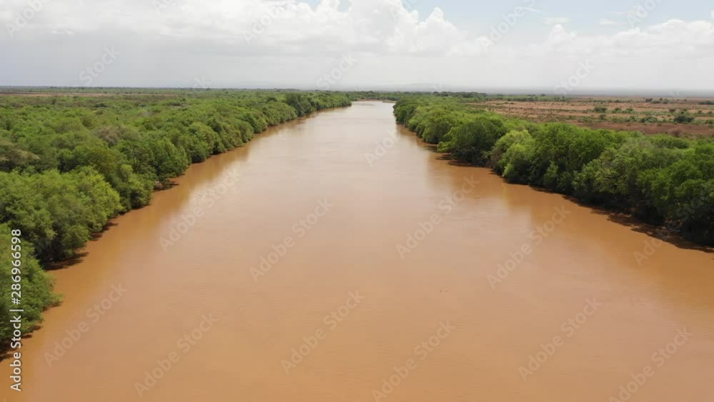 Low angle aerial view of Omorate river flowing through Ethiopia, close to the border with Kenya, natural scenery and landscapes in Africa Low angle aerial view of Omorate river flowing through Ethiopia, close to the border with Kenya, natural scenery and landscapes in Africa