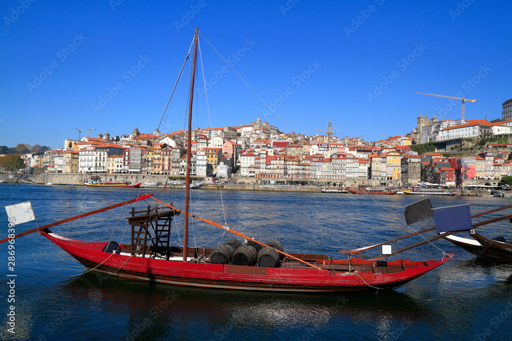 Traditional rabelo boats, Porto city skyline, Douro river and and Dom Luis or Luiz iron bridge. Porto