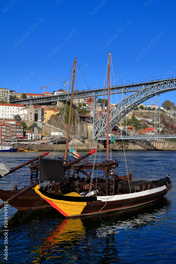 Traditional rabelo boats, Porto city skyline, Douro river and and Dom Luis or Luiz iron bridge. Porto