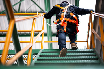 Construction worker wearing safety harness and safety line