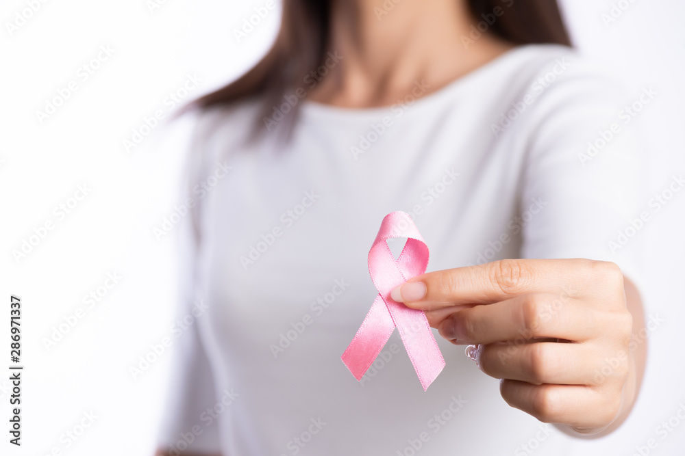womaen hand holding pink ribbon breast cancer awareness. concept healthcare and medicine. womaen hand holding pink ribbon breast cancer awareness. concept healthcare and medicine.