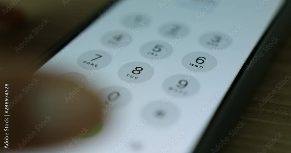 Hand making a call to press digital numbers on smart phone Hand making a call to press digital numbers on smart phone