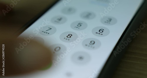 Hand making a call to press digital numbers on smart phone