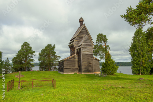 View of the old wooden church of St. George the Victorious (1492) on a cloudy August day. Rodionovo (Yuksovichi). Leningrad region, Russia