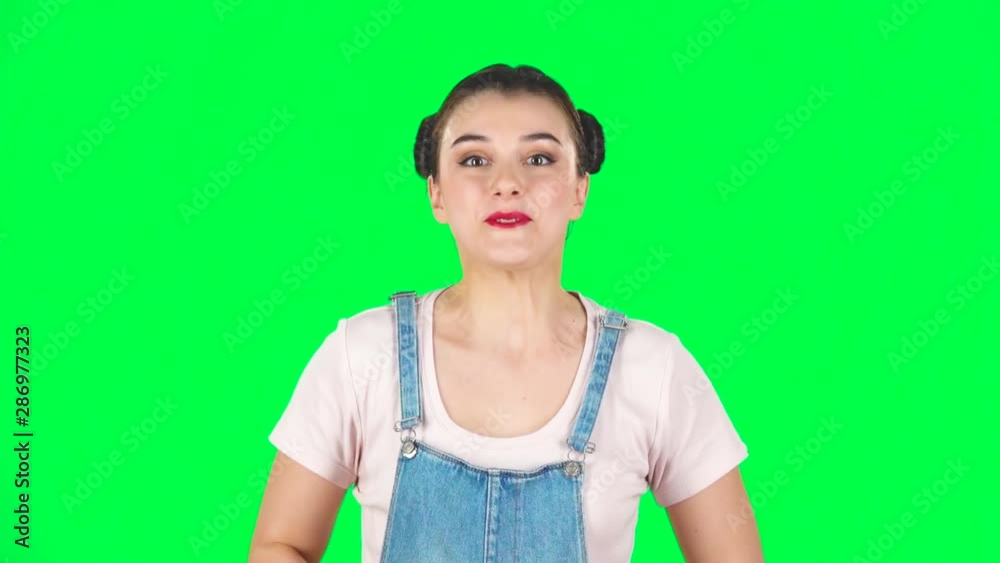 Cute woman looking at the camera with excitement, then celebrating her victory triumph on green screen. Slow motion Cute woman looking at the camera with excitement, then celebrating her victory triumph on green screen. Slow motion