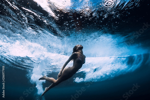 Photography Woman in bikini dive without surfboard underwater with ocean wave